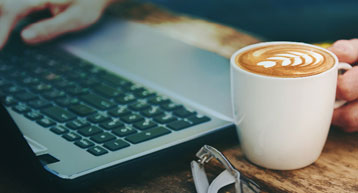 check in online laptop and coffee on table check in online laptop and coffee on table