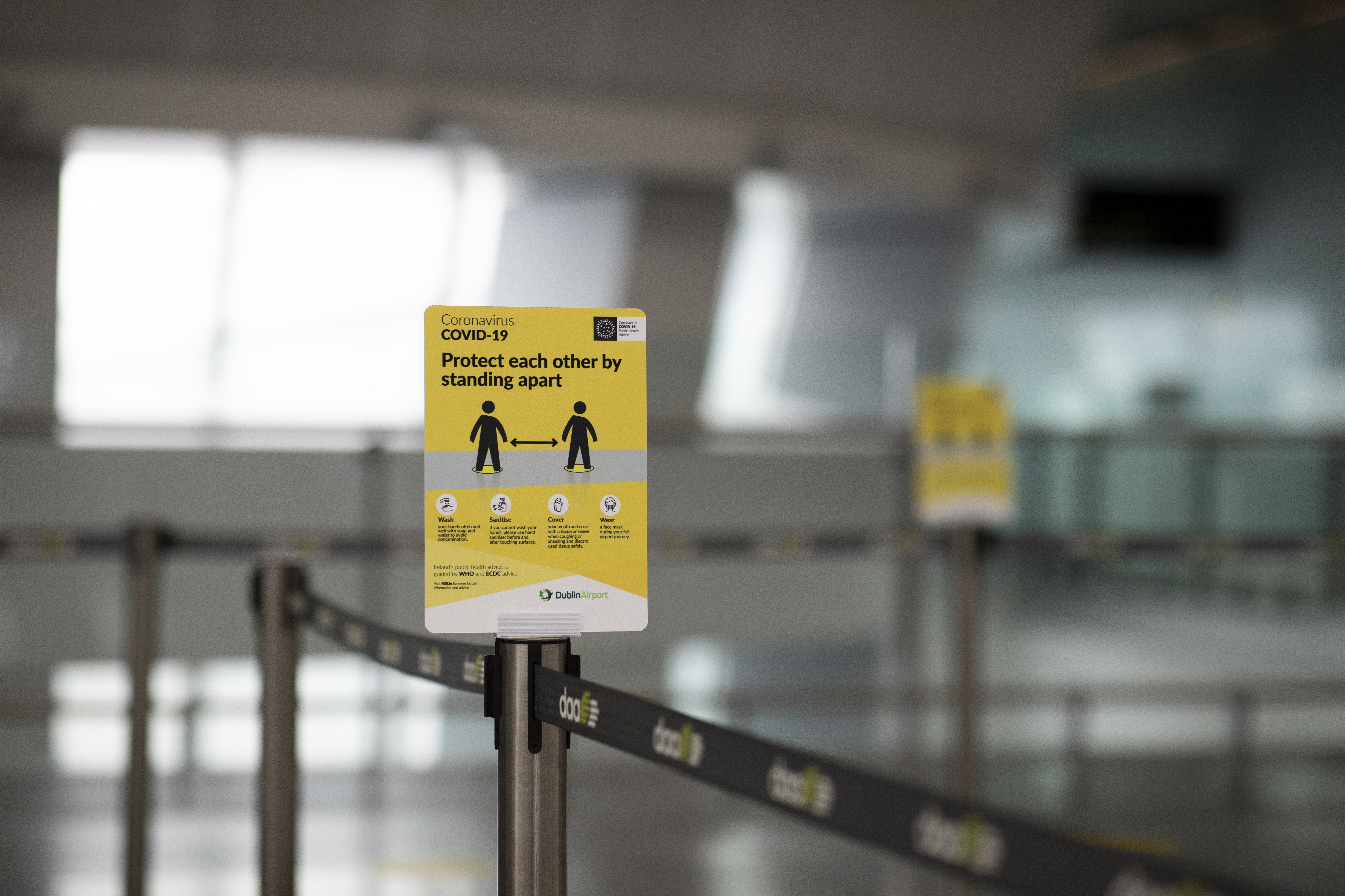 Social distancing signage in Q lane at Dublin Airport.