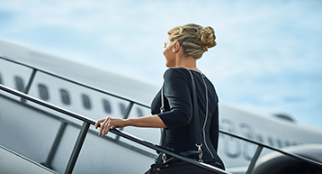 Woman going up aircraft departing Platinum Service Woman going up aircraft departing Platinum Service